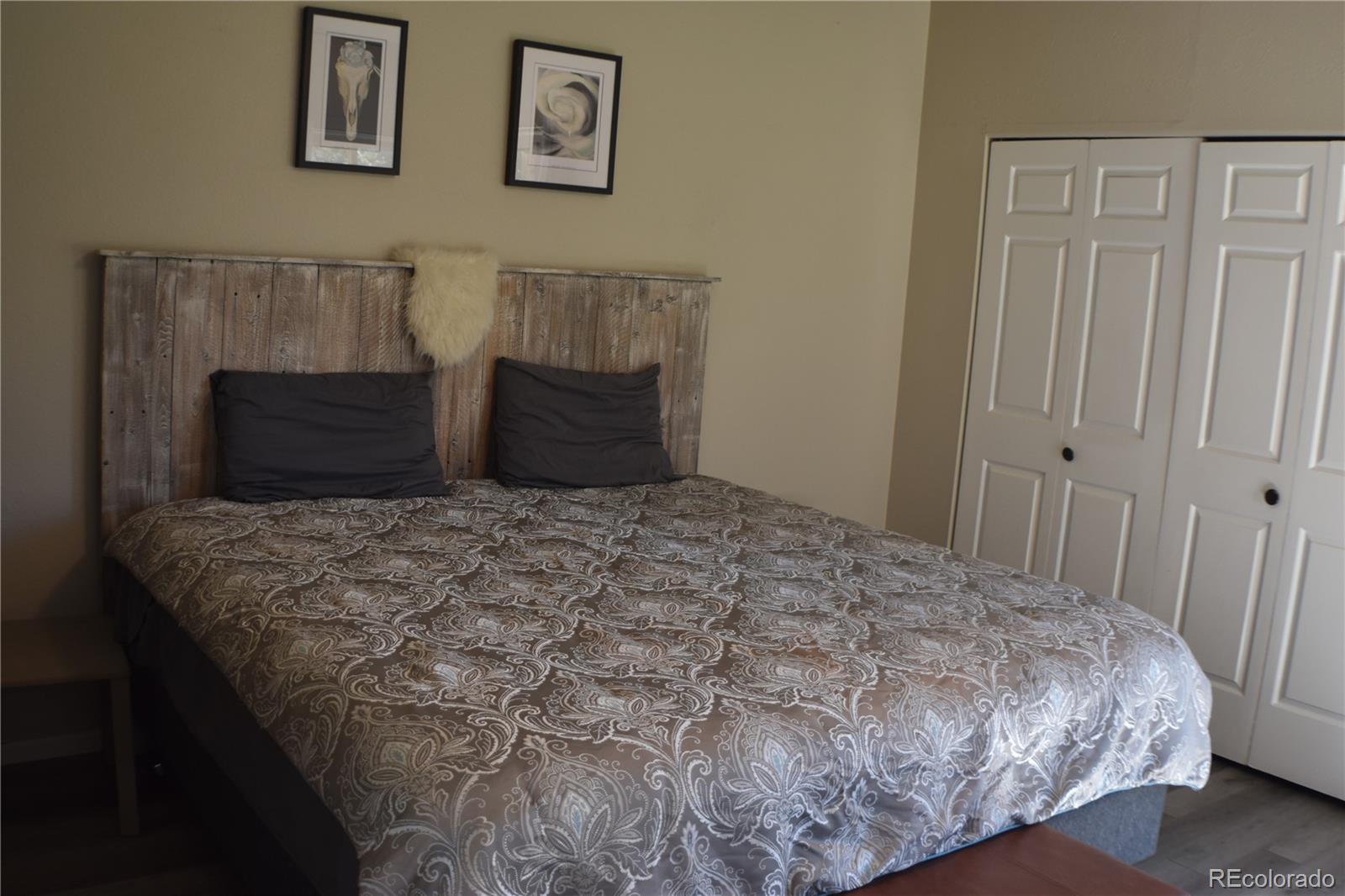 4075 Autumn Heights Drive, Unit F Colorado Springs, CO 80906 - Photo 24 of 44 a bedroom with a bed and painting on the wall