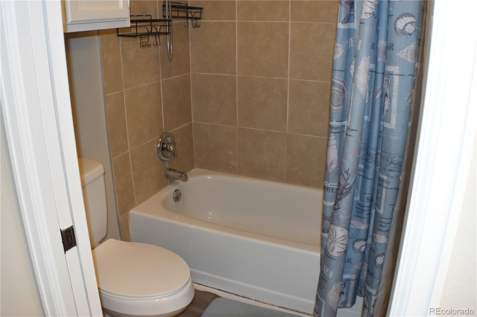 4075 Autumn Heights Drive, Unit F Colorado Springs, CO 80906 - Photo 28 of 44 a bath room with a toilet and a bath tub