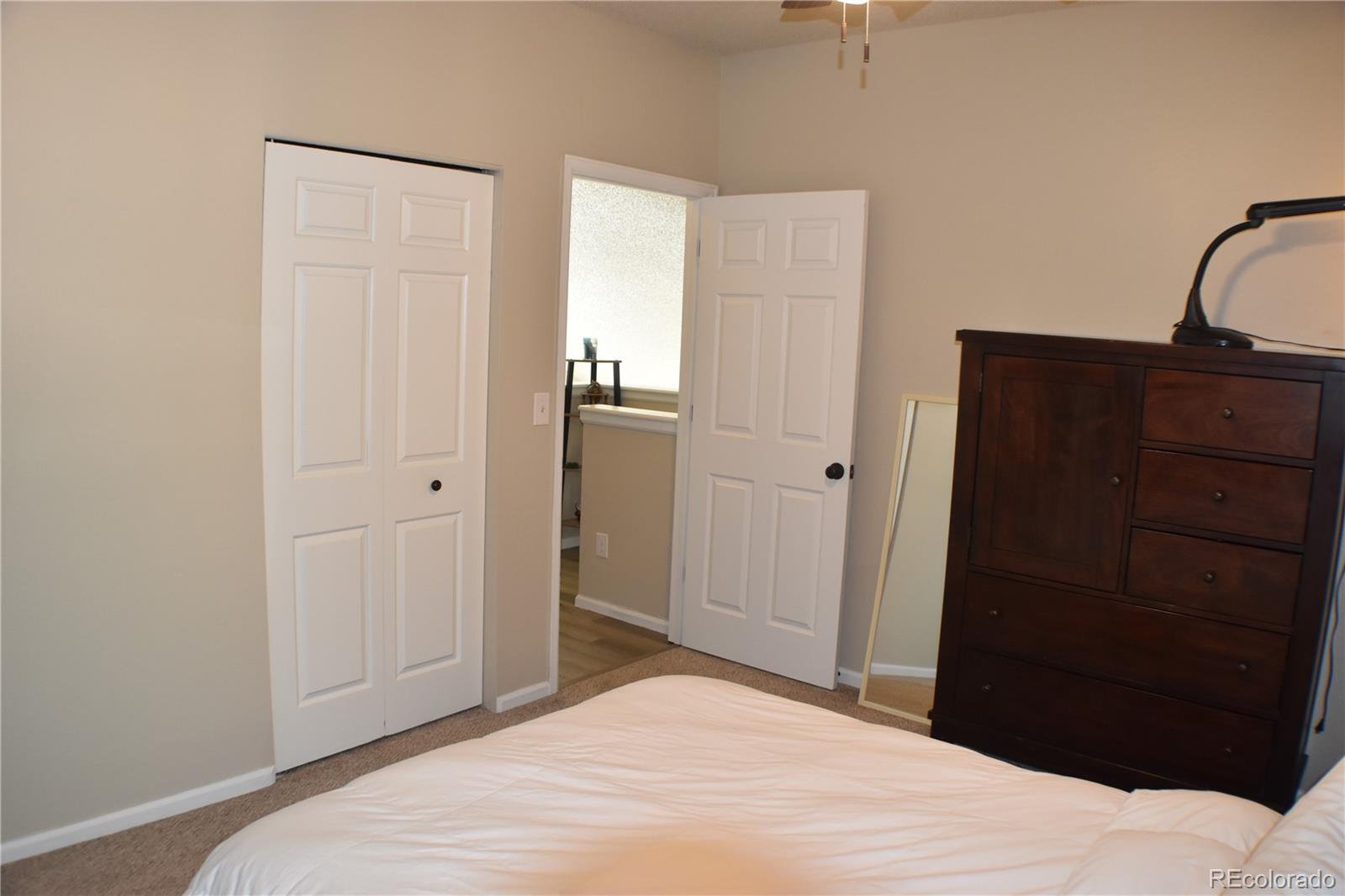 4075 Autumn Heights Drive, Unit F Colorado Springs, CO 80906 - Photo 32 of 44 a bedroom with a bed and a dresser