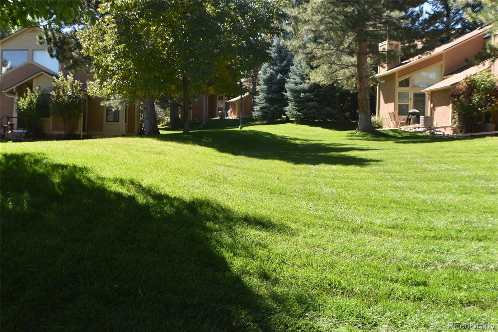 4075 Autumn Heights Drive, Unit F Colorado Springs, CO 80906 - Photo 37 of 44 a view of a house with a big yard