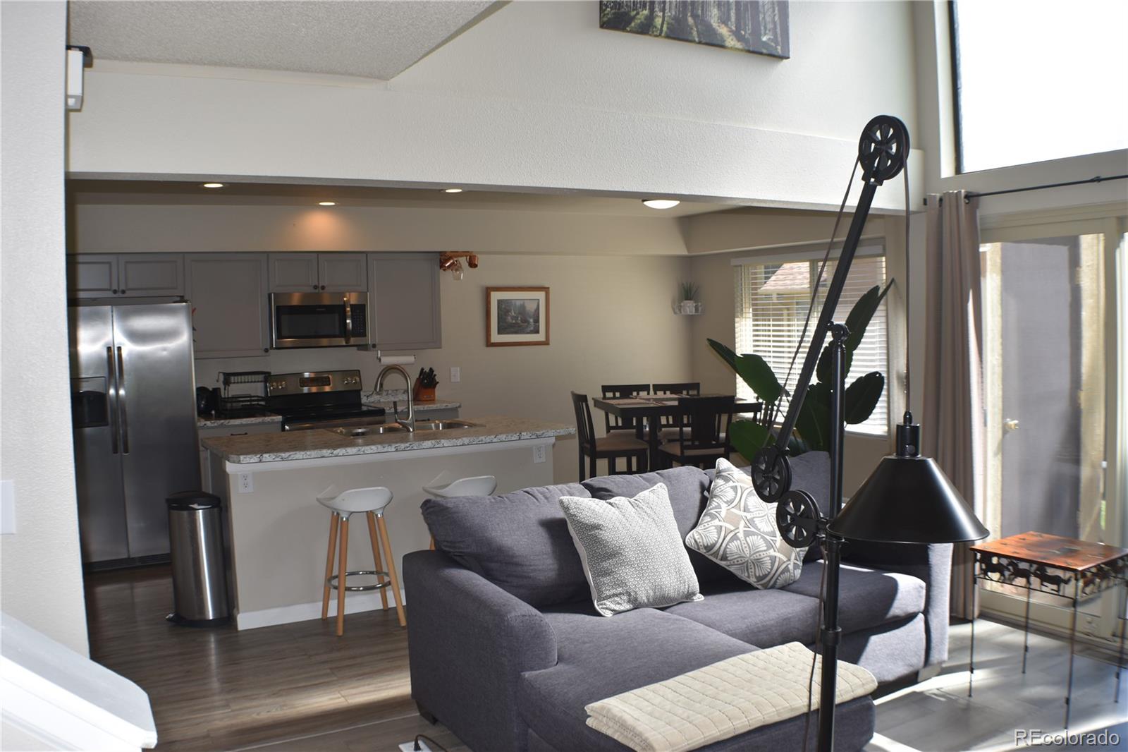 4075 Autumn Heights Drive, Unit F Colorado Springs, CO 80906 - Photo 4 of 44 a living room with furniture a flat screen tv and a window