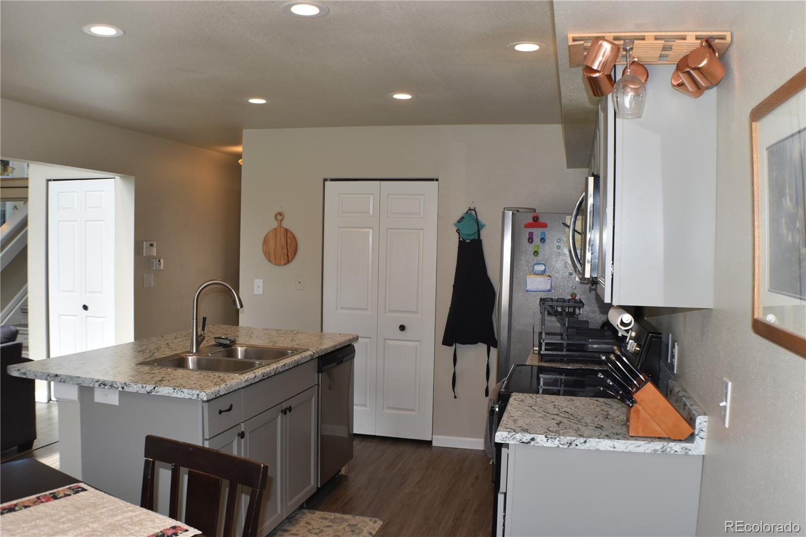 4075 Autumn Heights Drive, Unit F Colorado Springs, CO 80906 - Photo 7 of 44 a kitchen with stainless steel appliances granite countertop a sink stove and refrigerator