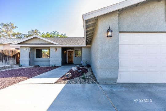 809 Valarie Street Ridgecrest, CA 93555 - Photo 4 of 8 a front view of a house with a garden