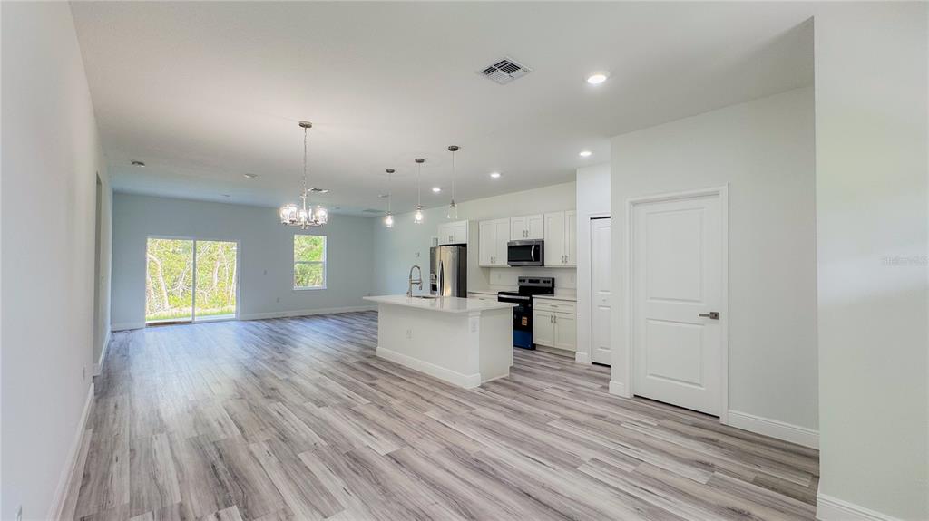 15625 Southwest 37th Circle Ocala, FL 34473 - Photo 4 of 27 a view of kitchen and hall with wooden floor