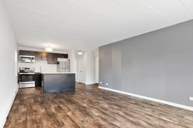 a view of kitchen and kitchen with stainless steel appliances
