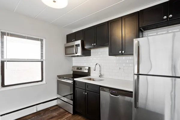a kitchen with a refrigerator sink and microwave