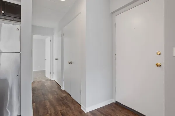 a view of a hallway with wooden floor