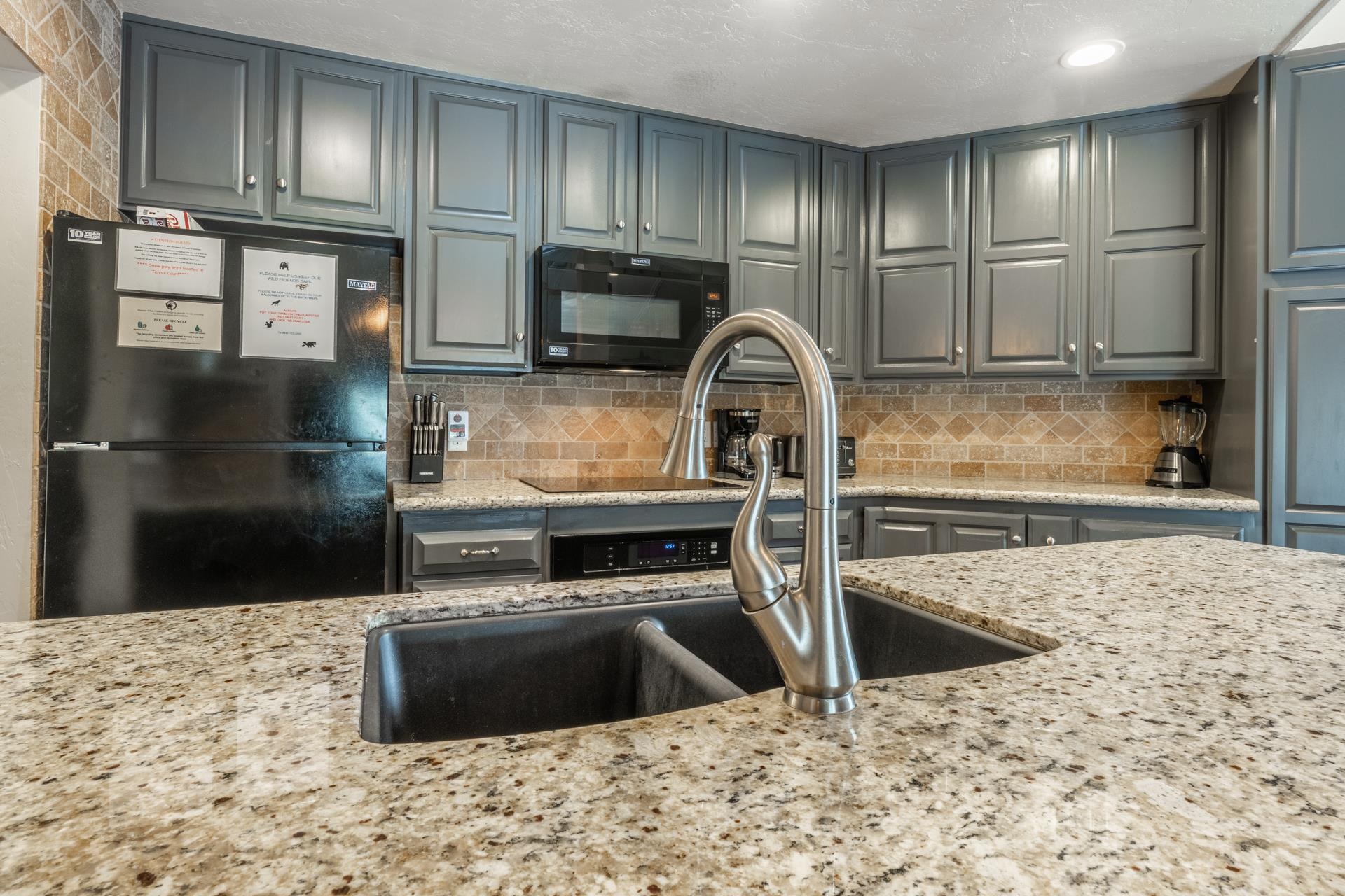 362 Old Mammoth Road, Unit 4 Mammoth Lakes, CA 93546 - Photo 11 of 50 Kitchen featuring black appliances, tasteful backsplash, and gray cabinets