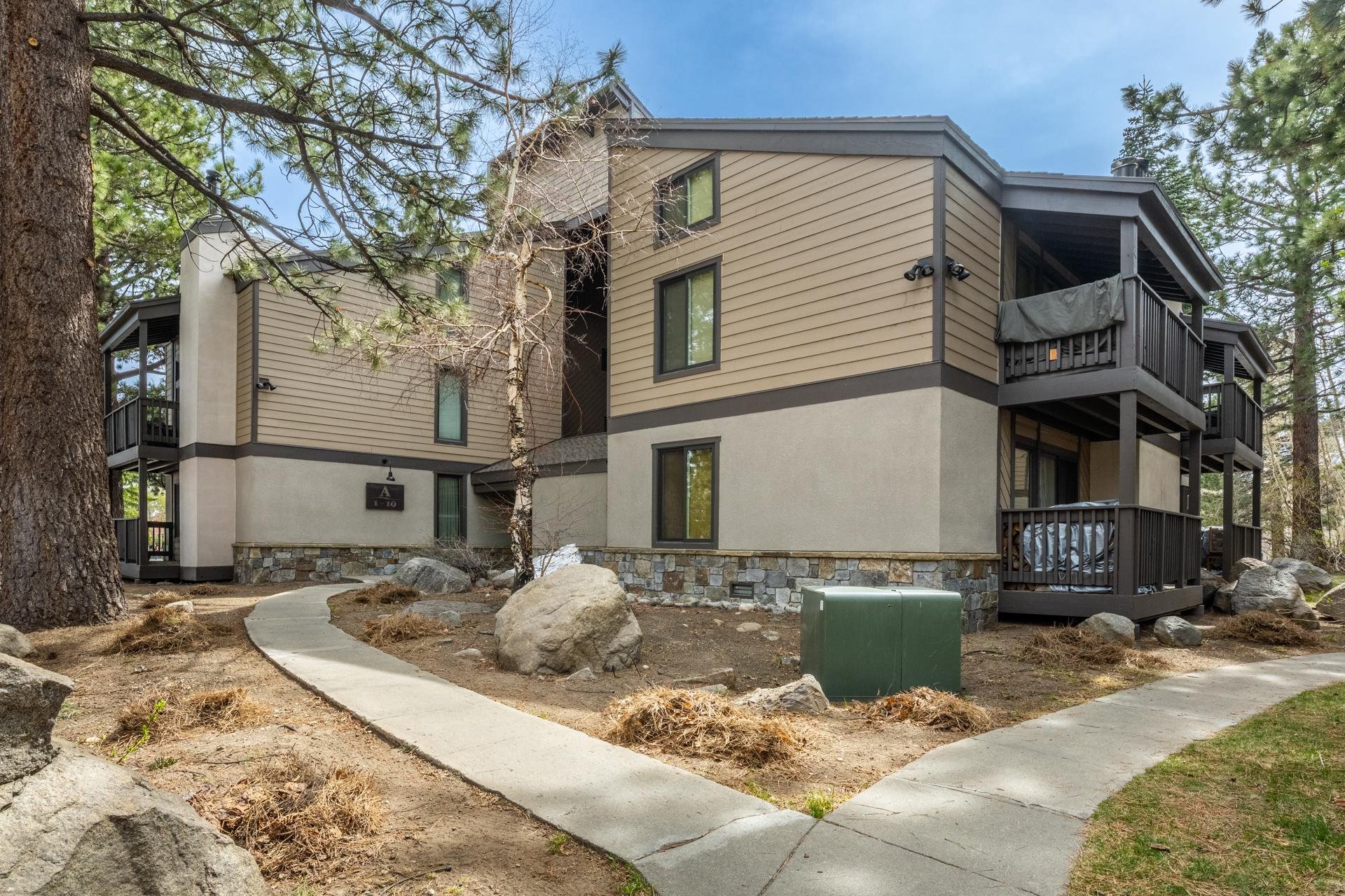 362 Old Mammoth Road, Unit 4 Mammoth Lakes, CA 93546 - Photo 39 of 50 View of side of home with a balcony, stucco siding, stone siding, and a chimney