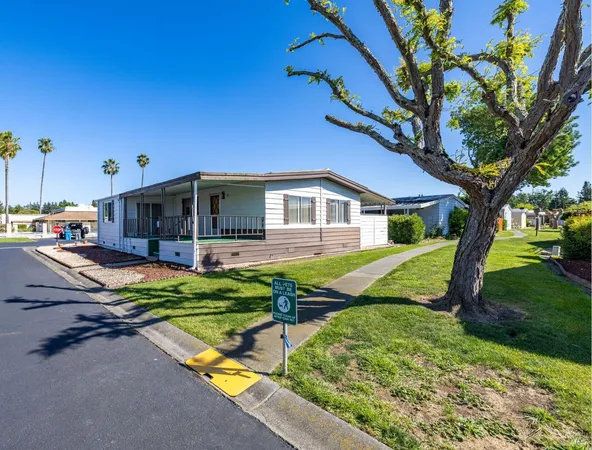 a front view of house with yard and outdoor seating