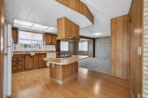 a kitchen with stainless steel appliances granite countertop a washer and dryer