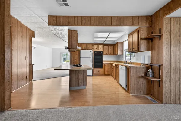 a kitchen with a stove a sink and a refrigerator