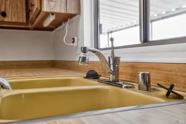 a view of a kitchen with refrigerator and a kitchen
