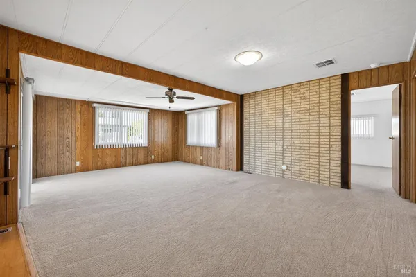 a view of a livingroom with a ceiling fan and window
