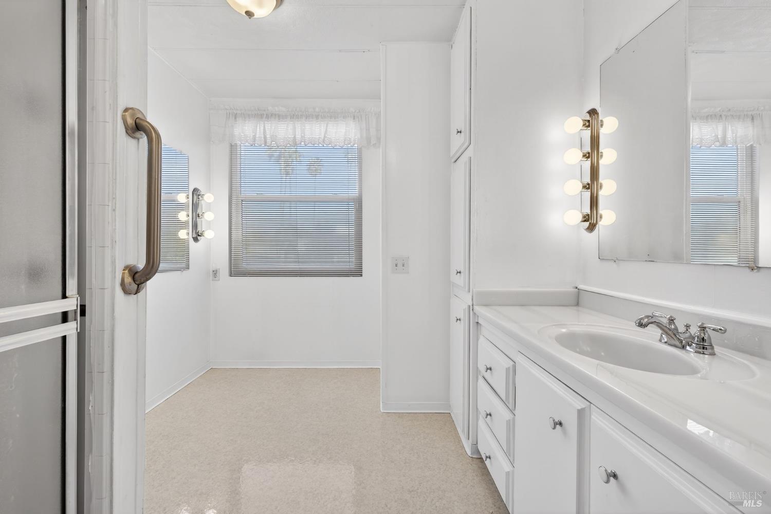 92 Anacapa Drive Santa Rosa, CA 95403 - Photo 33 of 46 a bathroom with a double vanity sink and mirror