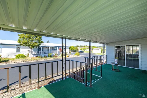 a view of a porch with furniture and garden
