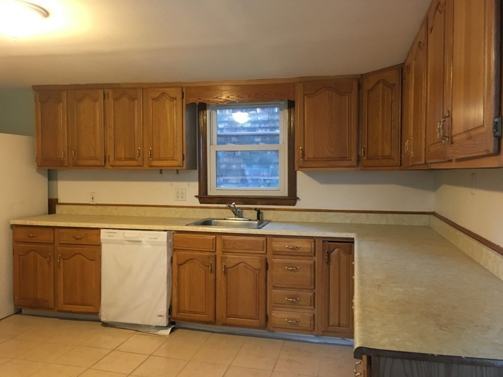 34 Grove Street Lynn, MA 01905 - Photo 15 of 37 a kitchen with a sink and cabinets