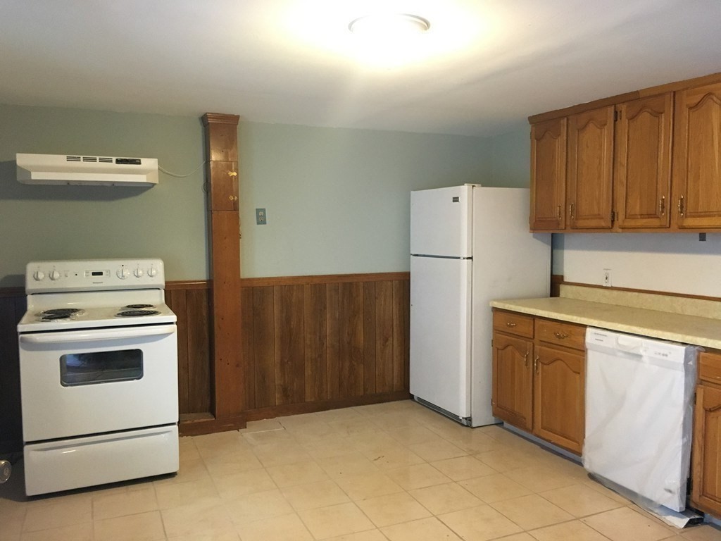 34 Grove Street Lynn, MA 01905 - Photo 16 of 37 a kitchen with a stove top oven and refrigerator