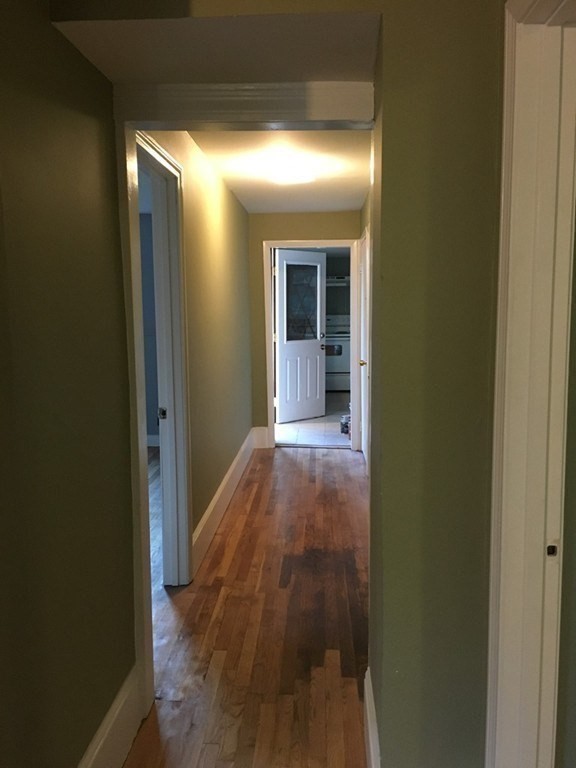 34 Grove Street Lynn, MA 01905 - Photo 17 of 37 a view of a hallway with wooden floor