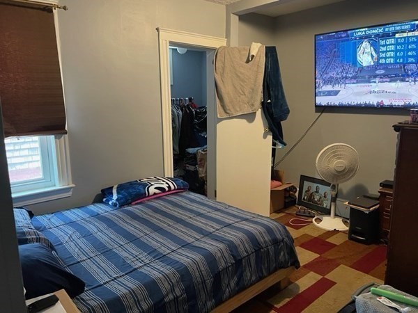 34 Grove Street Lynn, MA 01905 - Photo 23 of 37 a bedroom with a bed a mirror and dresser