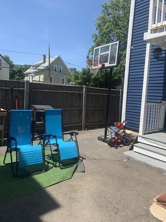 34 Grove Street Lynn, MA 01905 - Photo 29 of 37 a view of a chairs and tables in the back yard of the house