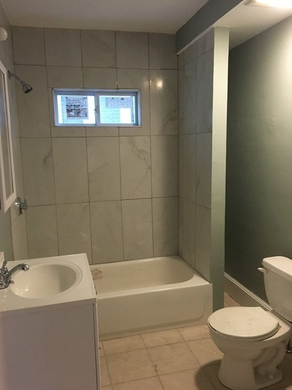 34 Grove Street Lynn, MA 01905 - Photo 3 of 37 a bath room with a toilet and a bath tub