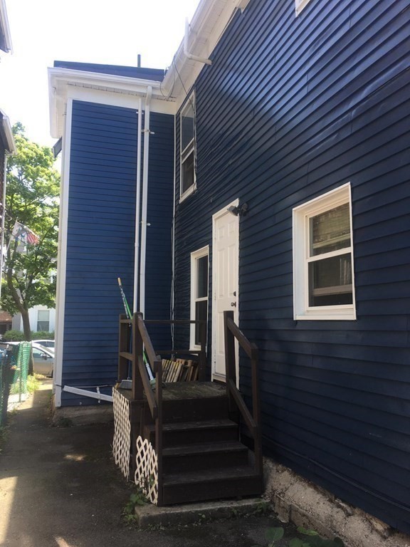 34 Grove Street Lynn, MA 01905 - Photo 31 of 37 a front view of a house with a small yard