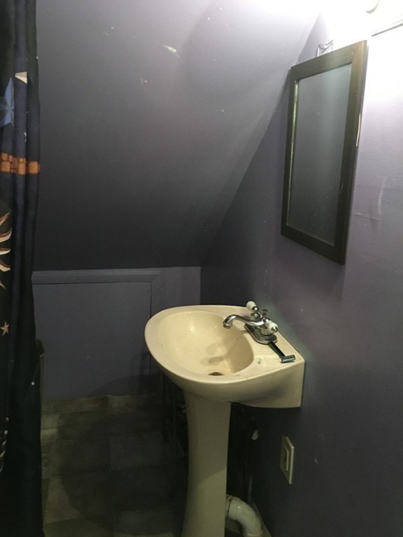 34 Grove Street Lynn, MA 01905 - Photo 6 of 37 a bathroom with a sink a mirror and vanity