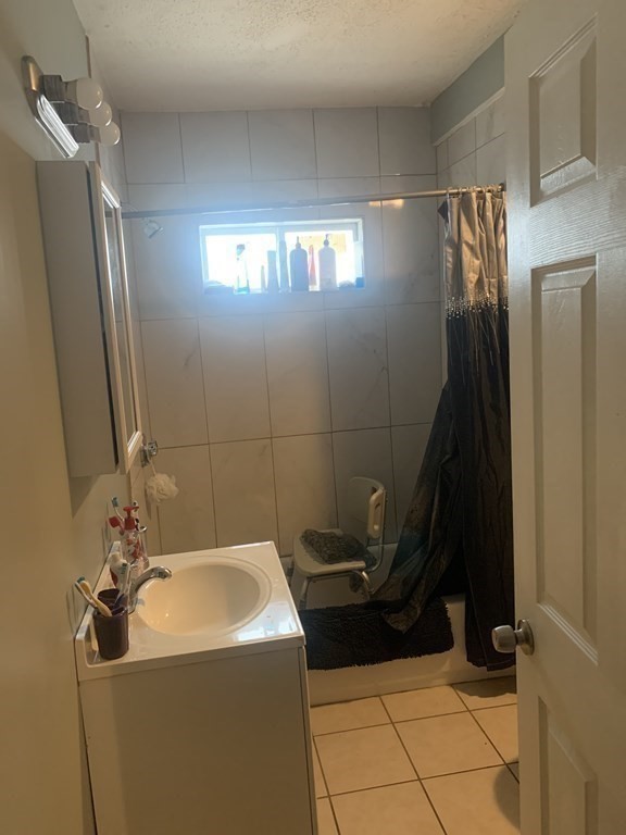 34 Grove Street Lynn, MA 01905 - Photo 7 of 37 a bathroom with a sink a toilet and mirror