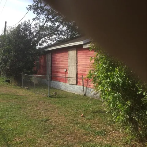 a backyard of a house with lots of green space and fountain