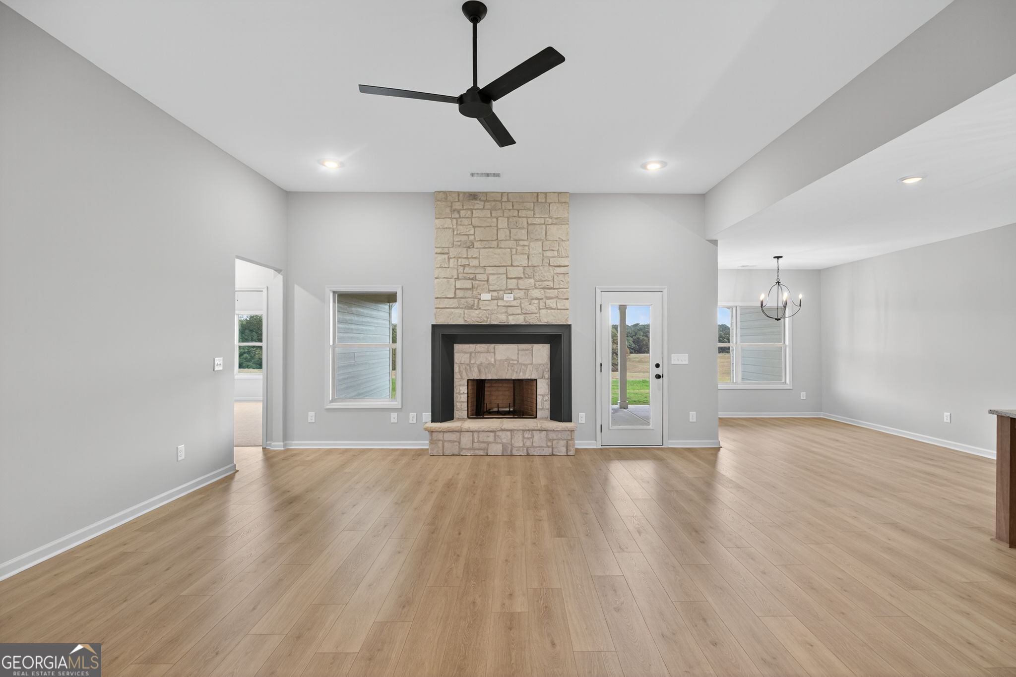 359 Gray Road Roopville, GA 30170 - Photo 13 of 46 a view of an empty room with wooden floor fireplace and a window