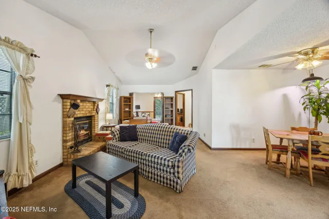 a living room with furniture a dining table and a piano table