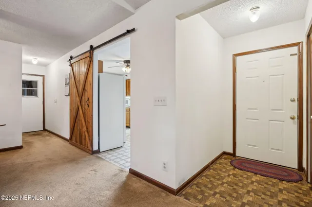 an empty room with closet and wooden floor