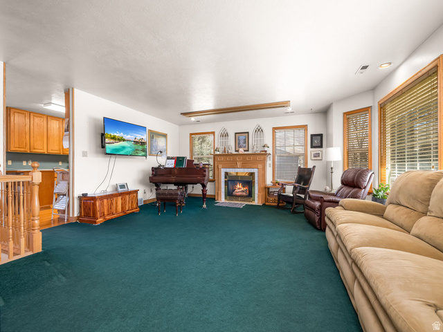 598 West 1600th Street North Mapleton, UT 84664 - Photo 3 of 34 Carpeted living area featuring a tile fireplace