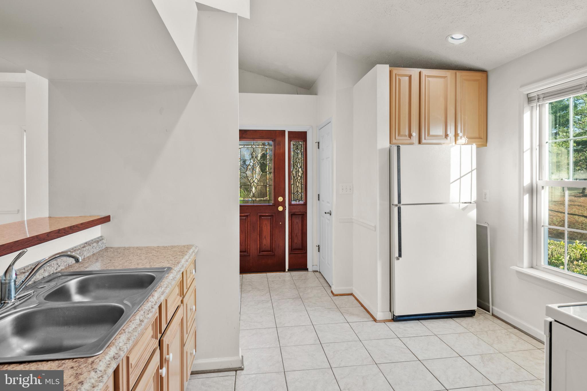 5885 Ketch Road Prince Frederick, MD 20678 - Photo 32 of 83 a kitchen with a refrigerator sink and cabinets