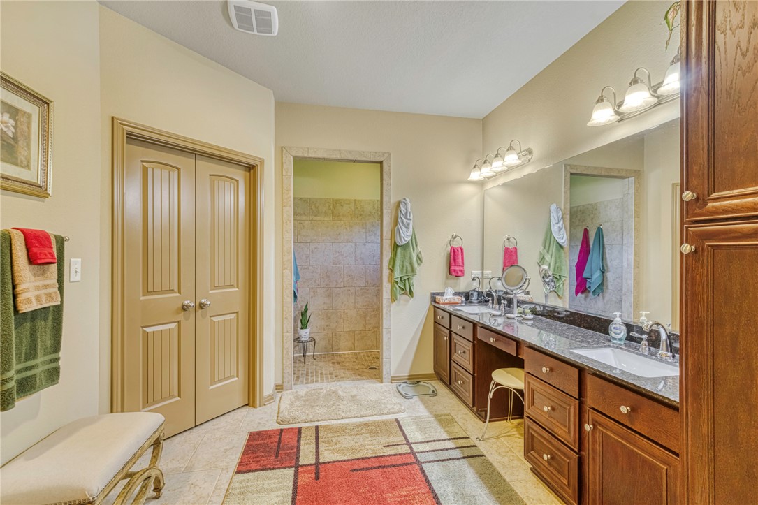 9945 Oxford Cemetery Road Madisonville, TX 77864 - Photo 19 of 42 Full bath with double vanity, walk in shower, and light tile patterned floors