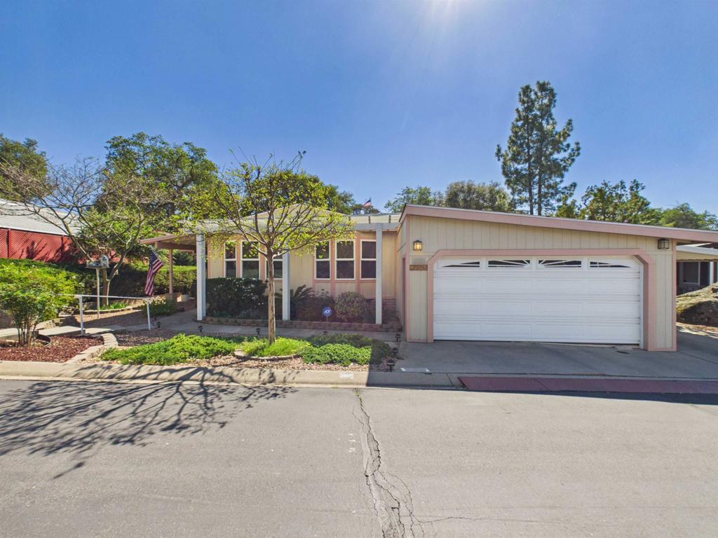 18218 Paradise Mountain Road, Unit 220 Valley Center, CA 92082 - Photo 47 of 48 a front view of a house with a yard and garage