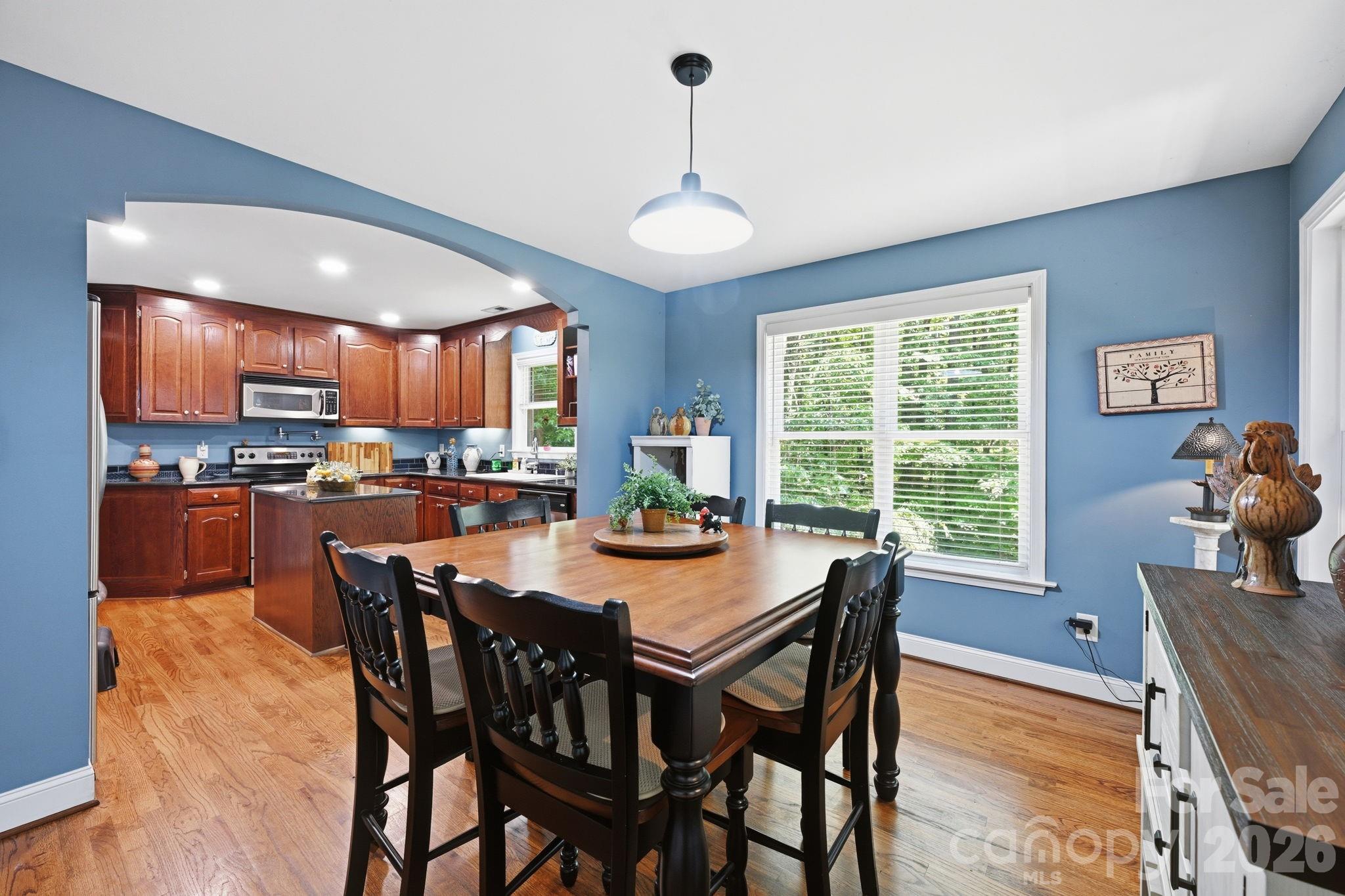 145 Upper Spencer Mountain Road Stanley, NC 28164 - Photo 17 of 29 a dining room with furniture a chandelier and window
