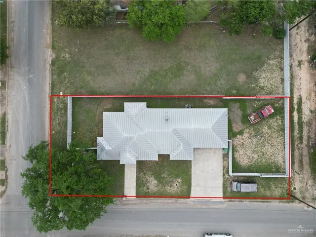 an aerial view of a house with a yard