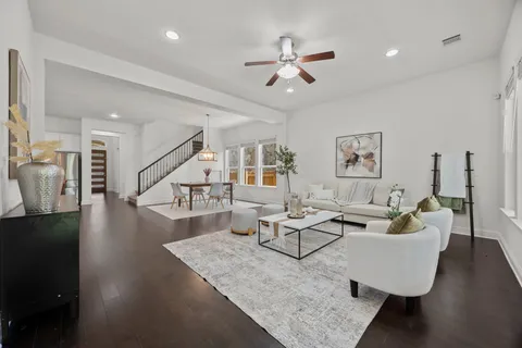 a living room with furniture and wooden floor