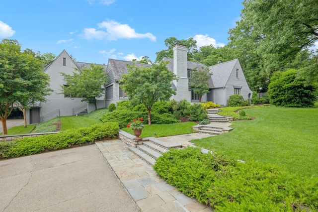 a view of a house with a yard and garden