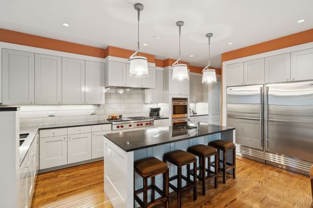 a view of a room with a large window and wooden floor