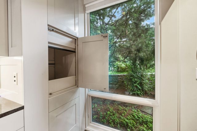 a living room with furniture a flat screen tv and a window