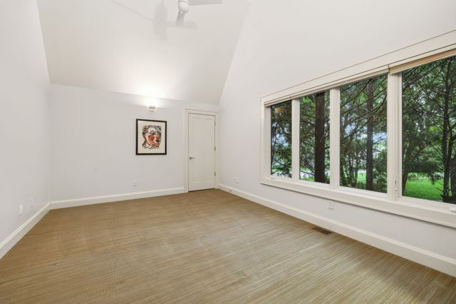 a bathroom with a granite countertop sink and large window