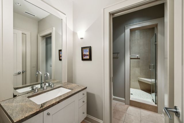a view of a patio with table and chairs under an umbrella