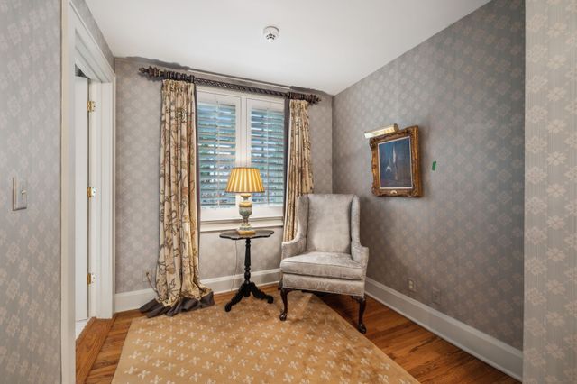a living room with furniture a fireplace and wooden floor