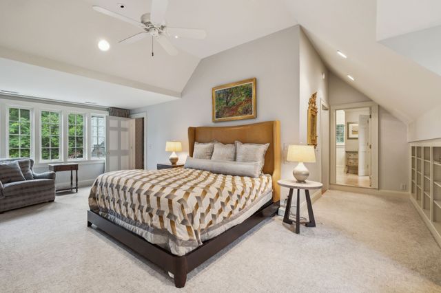 a living room with furniture a floor to ceiling window and flat screen tv