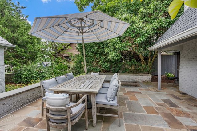 a front view of a house with lots of green space