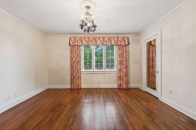 a living room with fireplace furniture and a large window