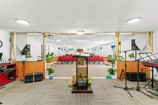 a view of a house with backyard and sitting area